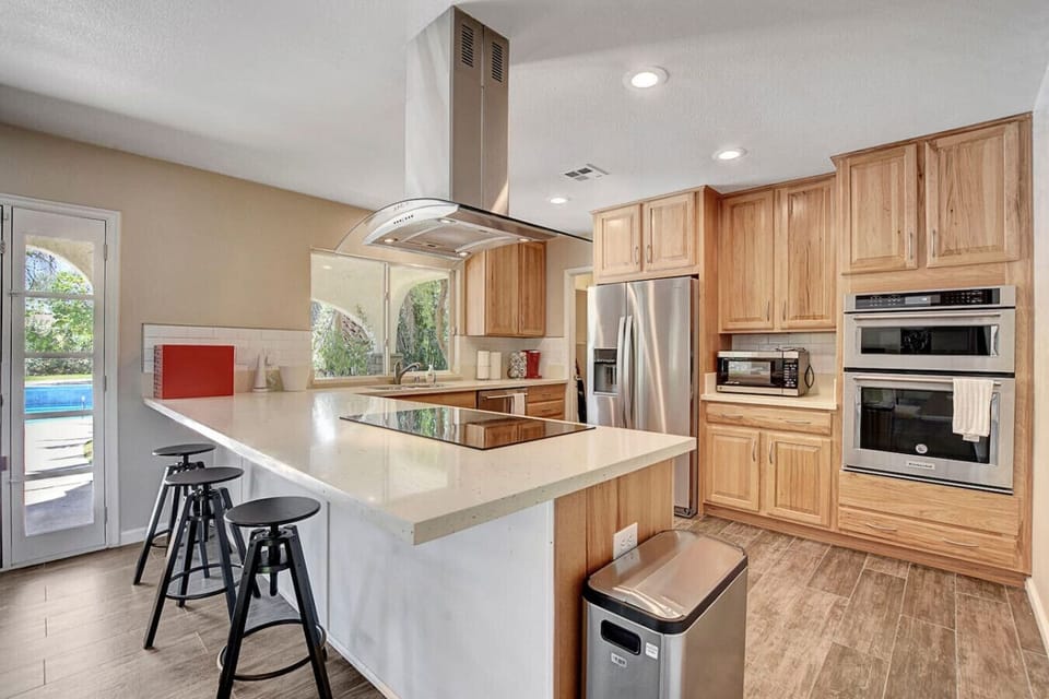 Spacious kitchen with island and stainless appliances
