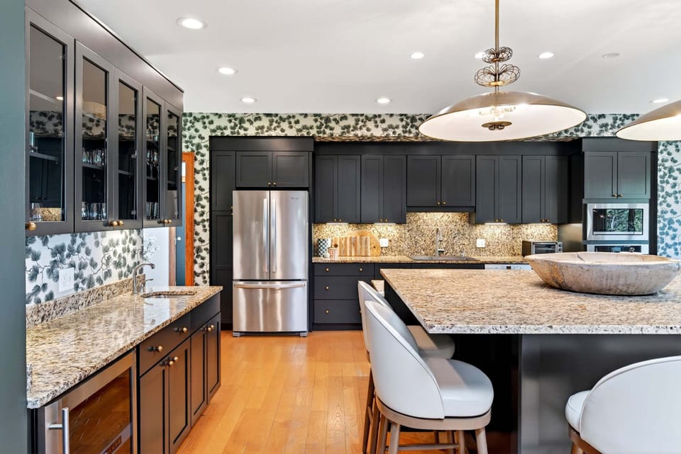 Well-equipped kitchen with gas range, dishwasher, and luxe, oversized island with seating for 6