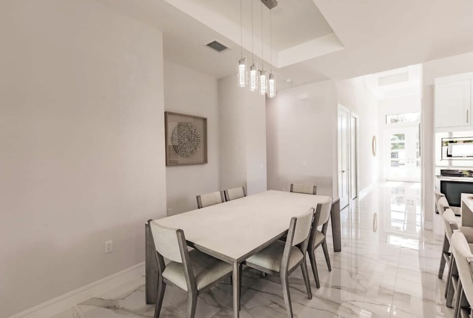 Sophisticated dining space with modern lighting, ideal for family meals and dinner parties.