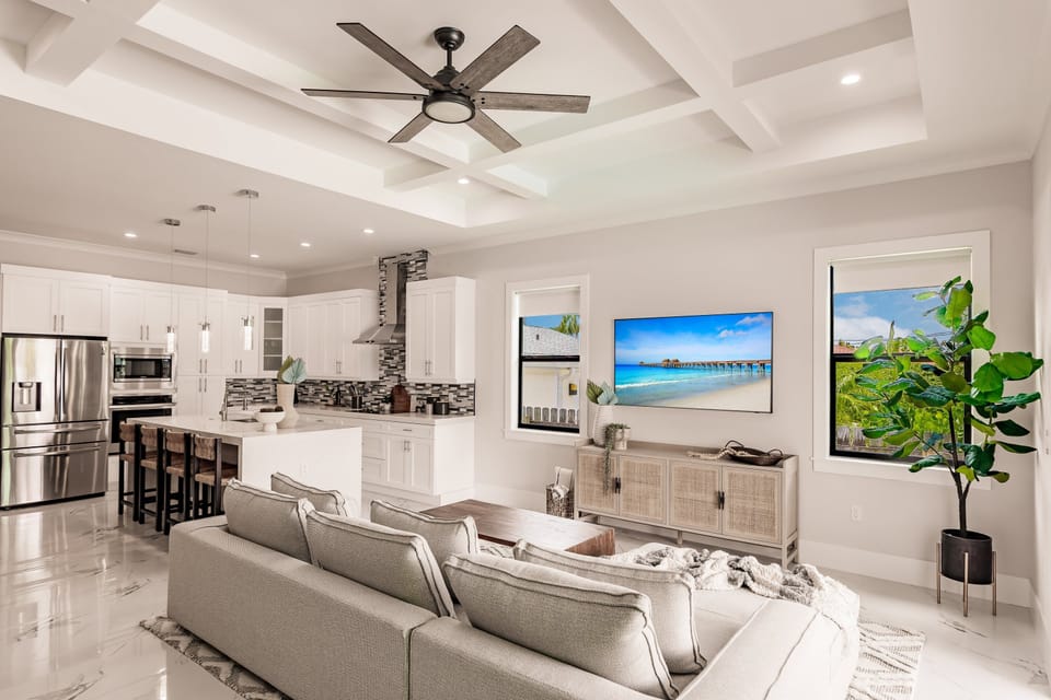 Relax in this airy open-concept living space with designer finishes and seamless access to the outdoor kitchen and pool patio.