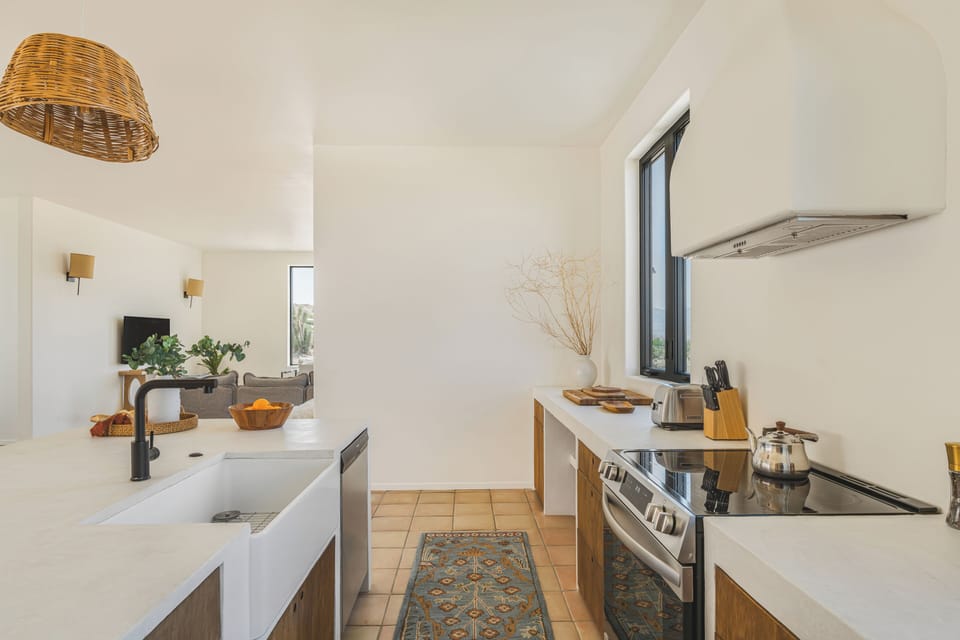 Fully equipped with high-end appliances and a deep farmhouse sink.