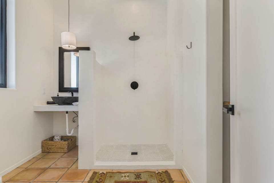 Floating vanities and designer fixtures throughout all bathrooms.