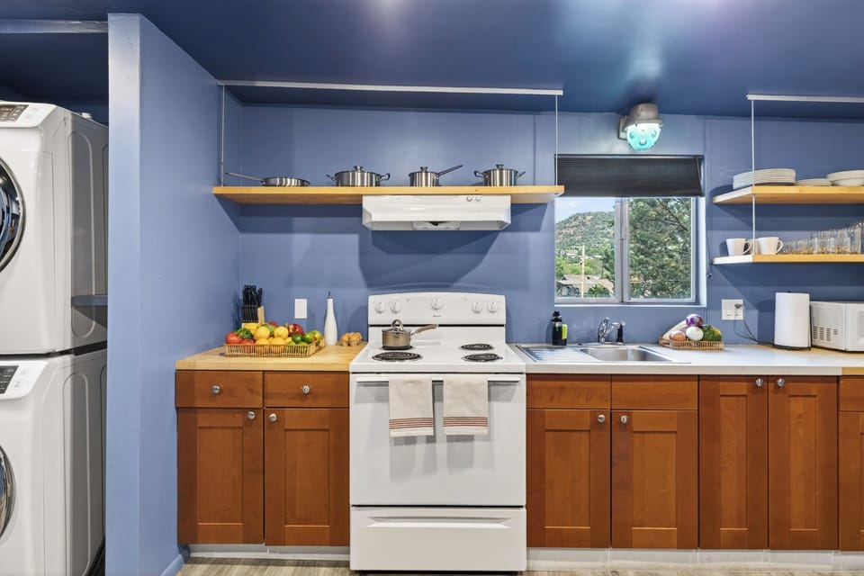 Whip up meals with ease in the full kitchenette featuring open shelving, cozy dining space, and everything you need for a comfortable stay. (Canyon Drift)