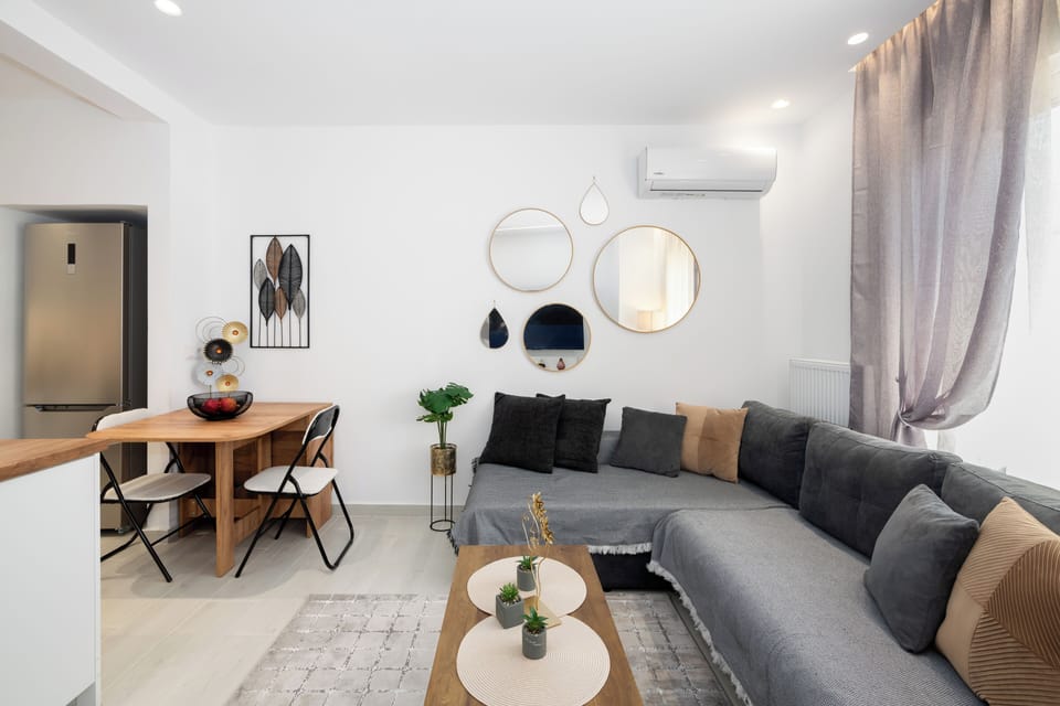 Cosy living space with plush grey sofa and warm-toned cushions.