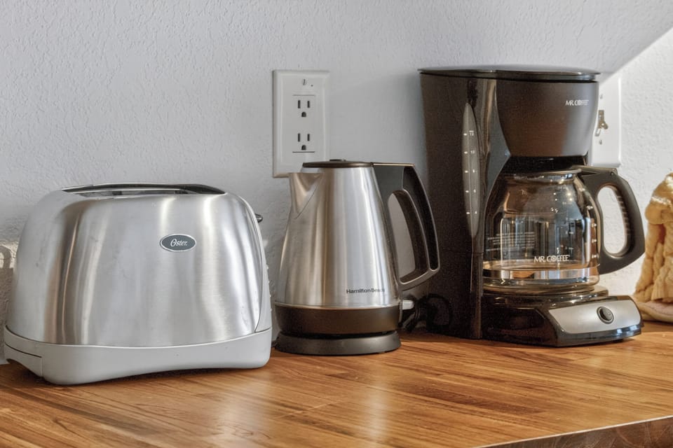 Start your mornings right with all the coffee and tea essentials at your fingertips—kettle, coffee maker, and toaster ready whenever you need them.