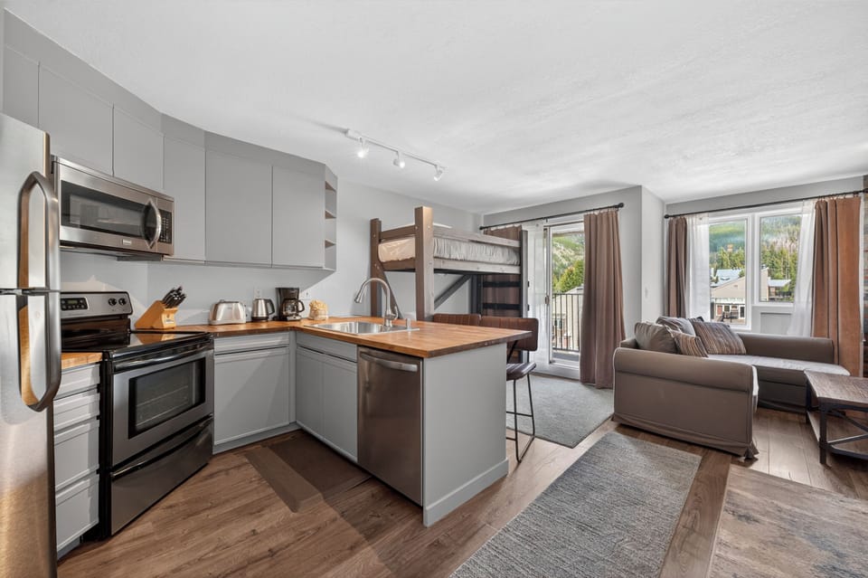 Step into your modern mountain retreat where sleek kitchen meets cozy living space. Cook, relax, and soak in those stunning views—all from one beautifully designed open layout.