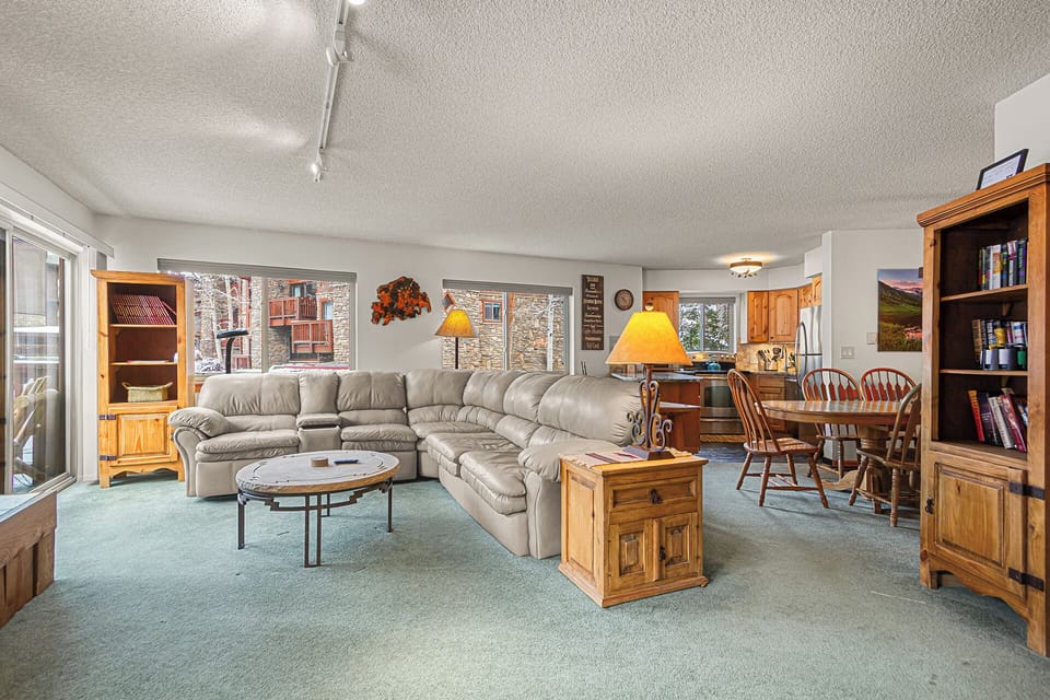Sink into the plush sectional and unwind in this spacious living area, where natural light and mountain charm create your perfect retreat after a day of adventure.