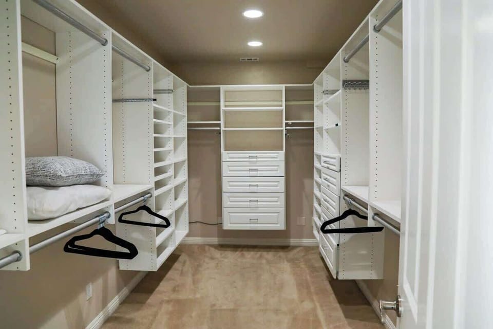 Primary bedroom walk in closet