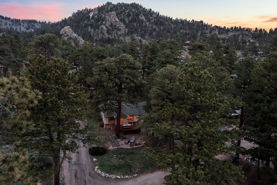 Tucked into the pines with a rocky peak as your backdrop — this is your home base for the mountains.