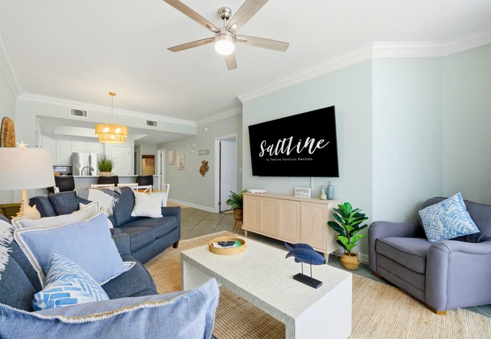 Warm coastal décor and sweeping water views create a space that feels both inviting and effortlessly relaxing.