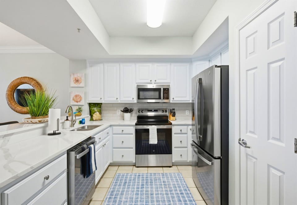Preparing meals is easy in this bright, spacious kitchen featuring plenty of counter space and modern appliances.