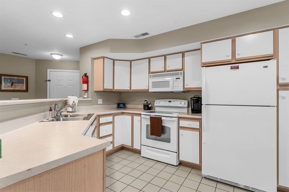 The open kitchen offers ample space & all the comforts of home​