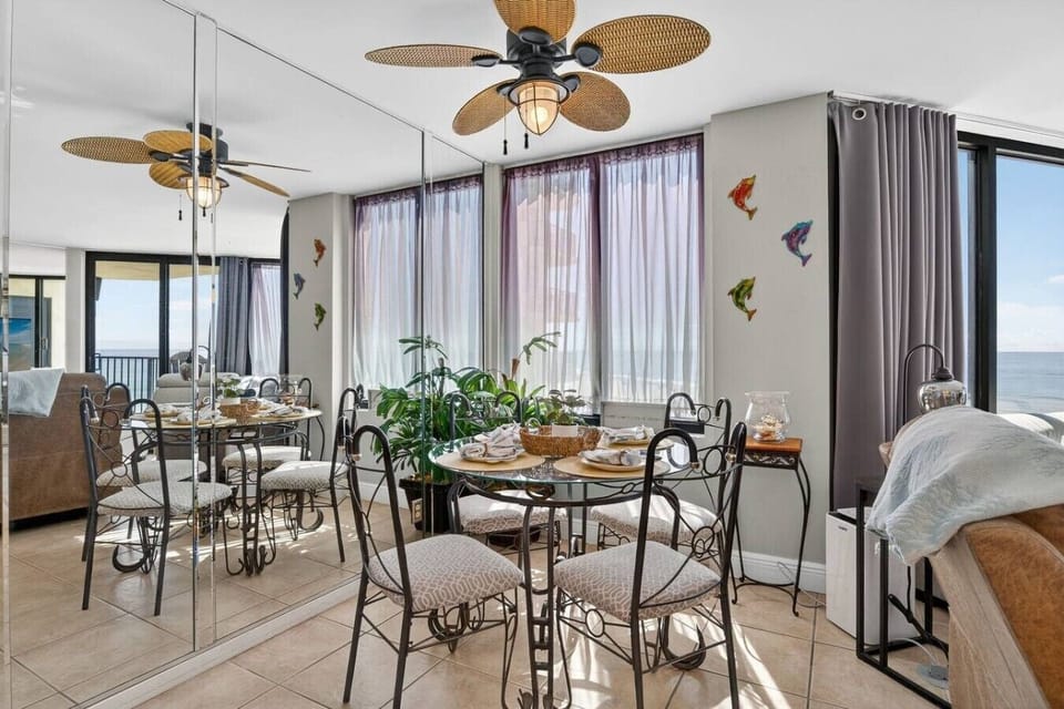 Cozy dining areAerial view of Sunbird Beach Resort with beachfront pools, direct beach access, and stunning Gulf waters.a with mirrored accents and natural light overlooking the Gulf.
