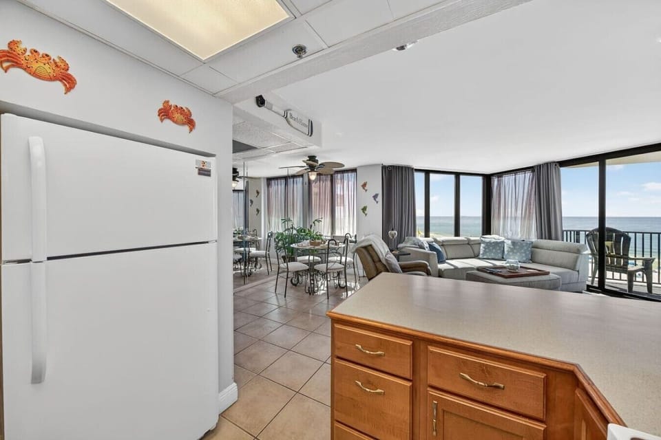 Open-concept kitchen overlooking the bright living area and stunning Gulf views.