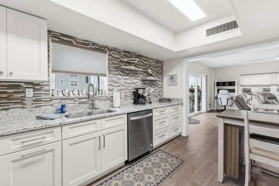 Updated Kitchen with Granite Counters and glass tile Backsplash