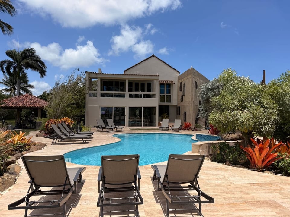 Resort Style Pool looking back at the large home