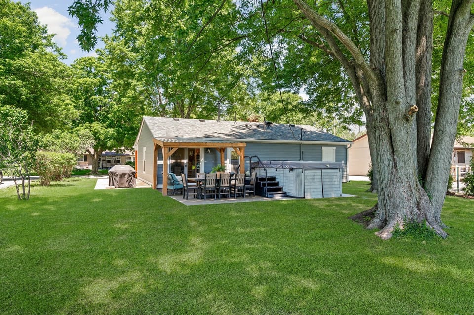 Enjoy the backyard oasis featuring a 14ft swim spa, outdoor dining for 8, grill, and comfortable seating area perfect for relaxing and spending time together.