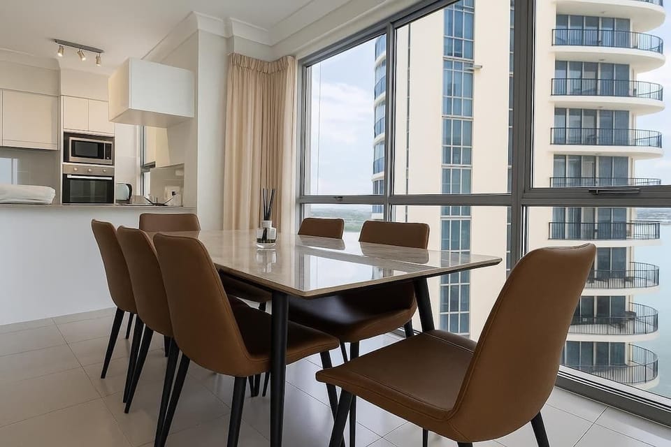 Dining space positioned by floor-to-ceiling windows