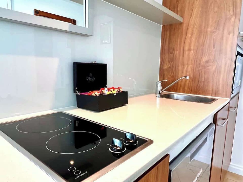Kitchenette includes two electric hotplates, microwave/convection oven, small dishwasher, and pots and pans provided 