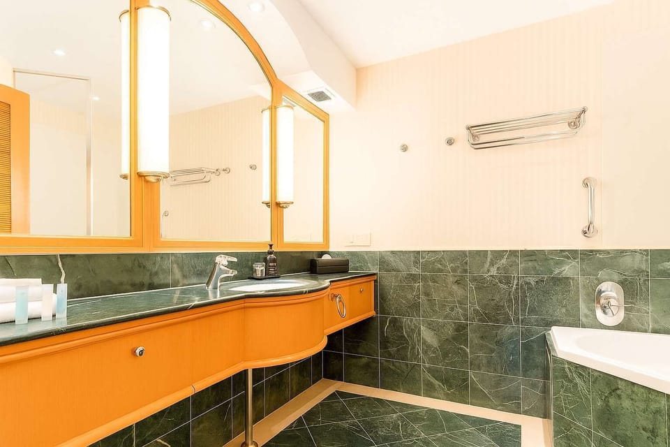 Marble bathroom with large mirror and quality fittings