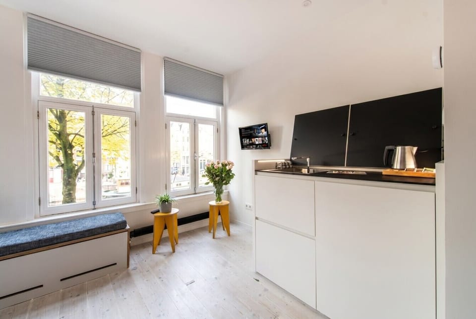 Sun-filled studio with treetop canal views.