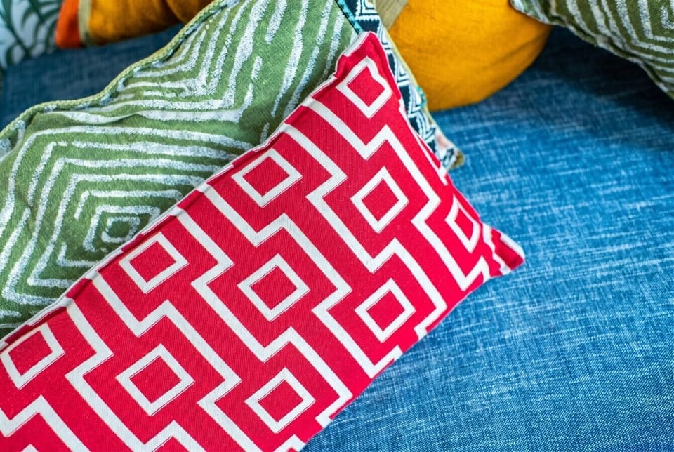 Bold patterned cushions add a playful pop of color.