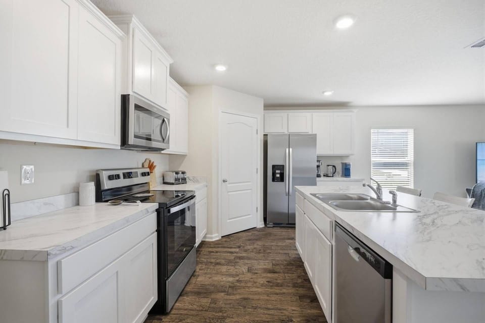 Fully equipped kitchen featuring generous counter space and bar seating for easy dining, conversation, and entertaining.
