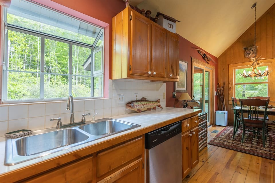 A charming garden window above the sink brings in natural light and peaceful views while you cook or clean up.