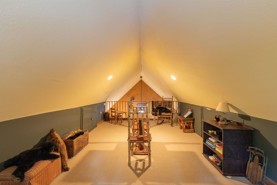 From the loft, guests can enjoy a unique elevated view of the cabin along with a small table perfect for games, snacks, or quiet moments indoors.