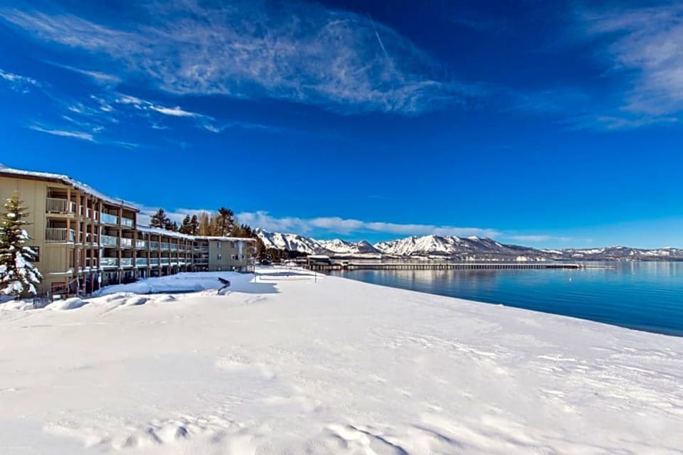 Breathe in crisp alpine air beside a serene frozen lake.