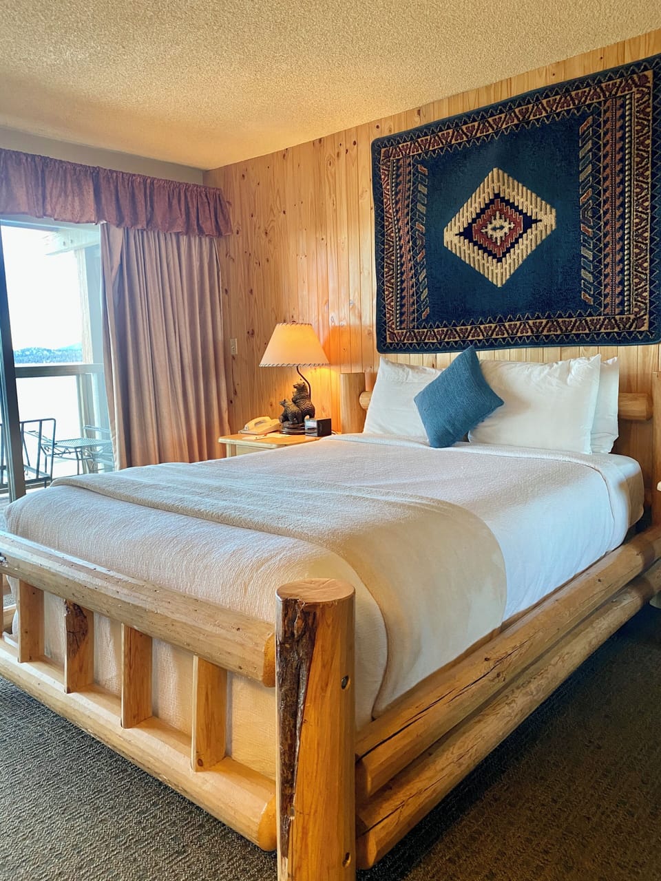 Unwind in a handcrafted log bed with cozy cabin charm.