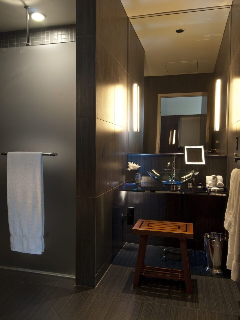 Recharge with a sleek, modern bath and bright mirror lighting.