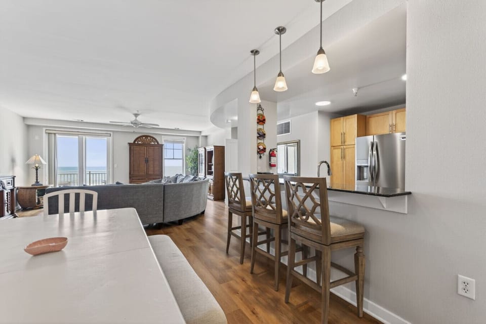 The open-concept layout keeps everyone connected—whether you`re cooking, dining, or relaxing with ocean views nearby.