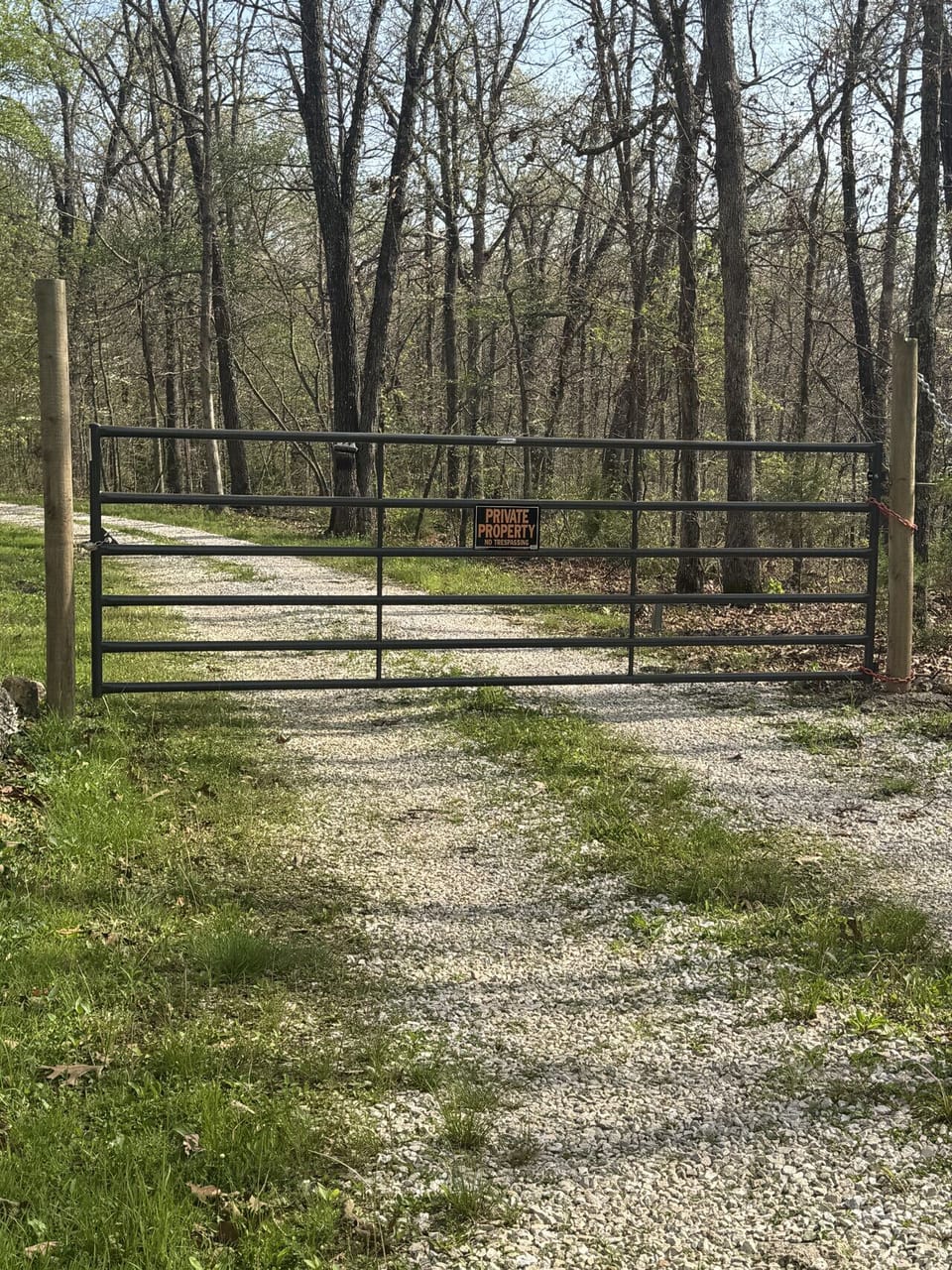 Private rural property with gated gravel driveway—secure, wooded land perfect for a peaceful retreat or homestead.