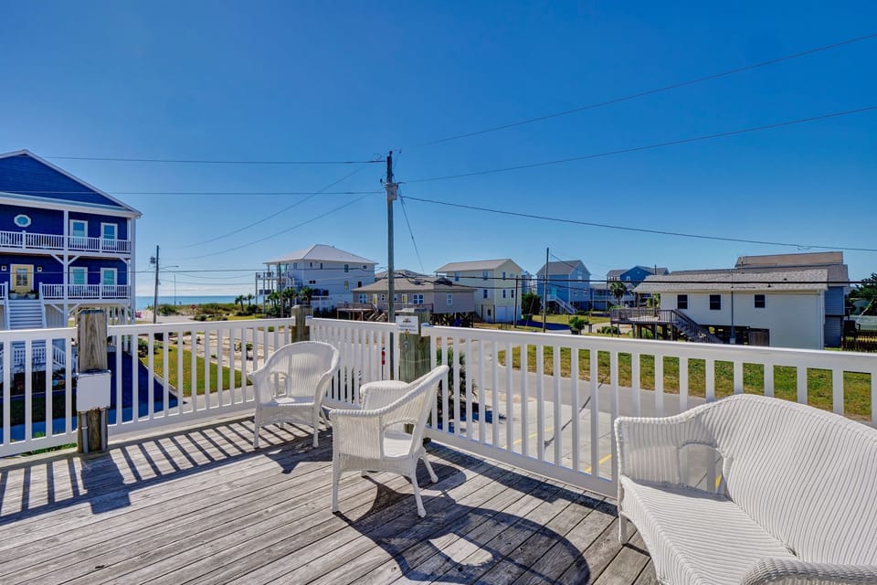 Enjoy coastal breezes from the shared community deck, great for relaxing, chatting, or soaking in the Surf City atmosphere steps from the beach 