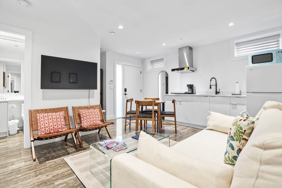 Living Room: Stylish modern space with plush seating, a sleek kitchen, and inviting decor. Enjoy!