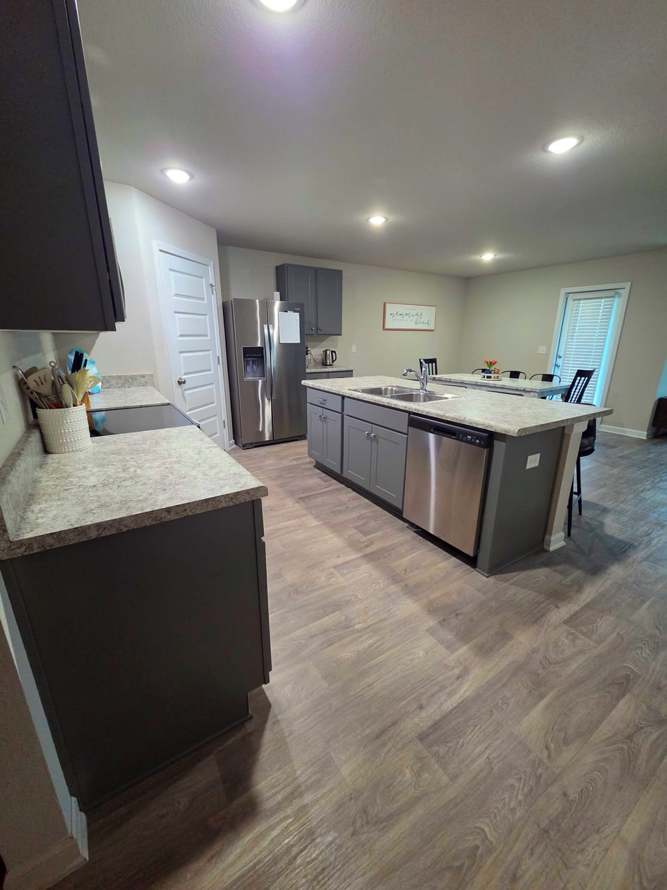 open kitchen with fridge, small appliances, stove, microwave, dish washer