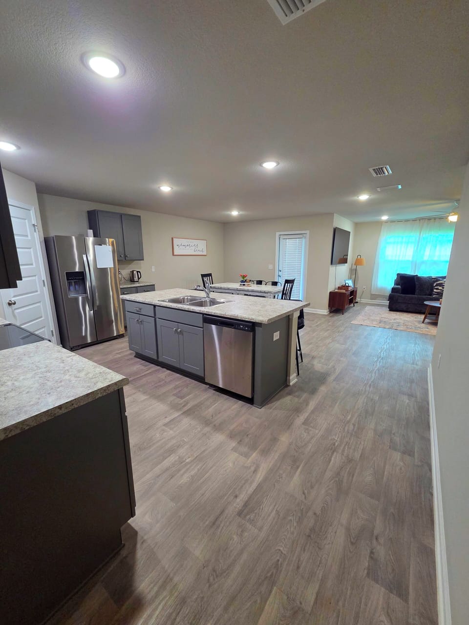 open kitchen with fridge, small appliances, stove, microwave, dish washer