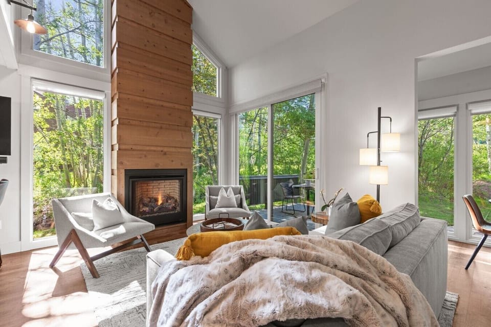 Enjoy mountain living at its best in this cozy ski condo with picturesque aspen and creek views. The inviting fireplace serves as the heart of the open living space, while the loft above adds a sense of spaciousness and rustic charm—perfect for relaxing a