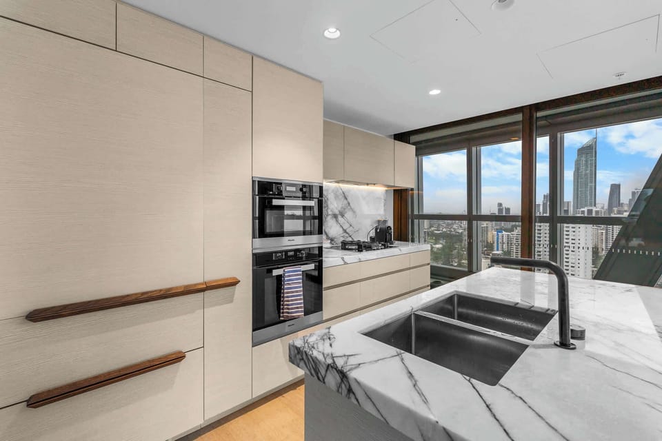 Fully equipped designer kitchen with premium Miele appliances, gas cooktop and beautiful marble finishes.
