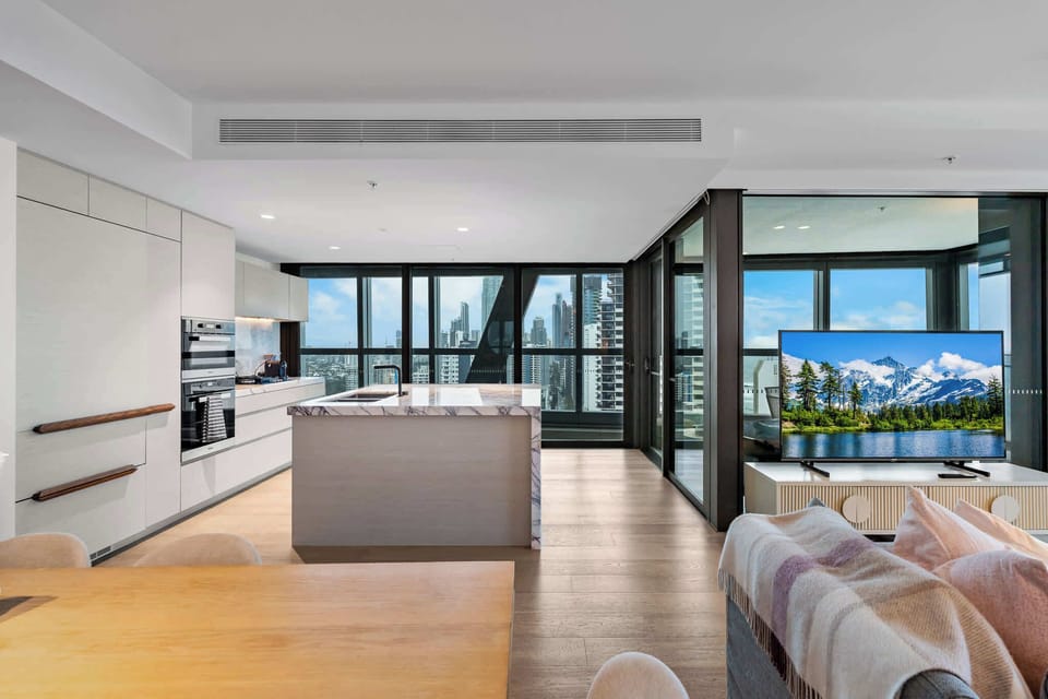Spacious open-plan kitchen, dining and living area with luxury finishes throughout.