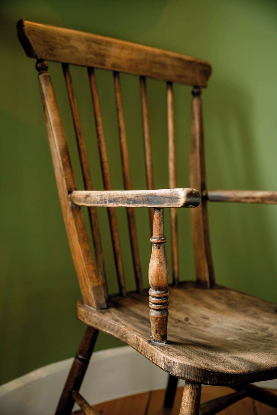 Rustic wooden chair tucked into a quiet corner for peaceful morning reading