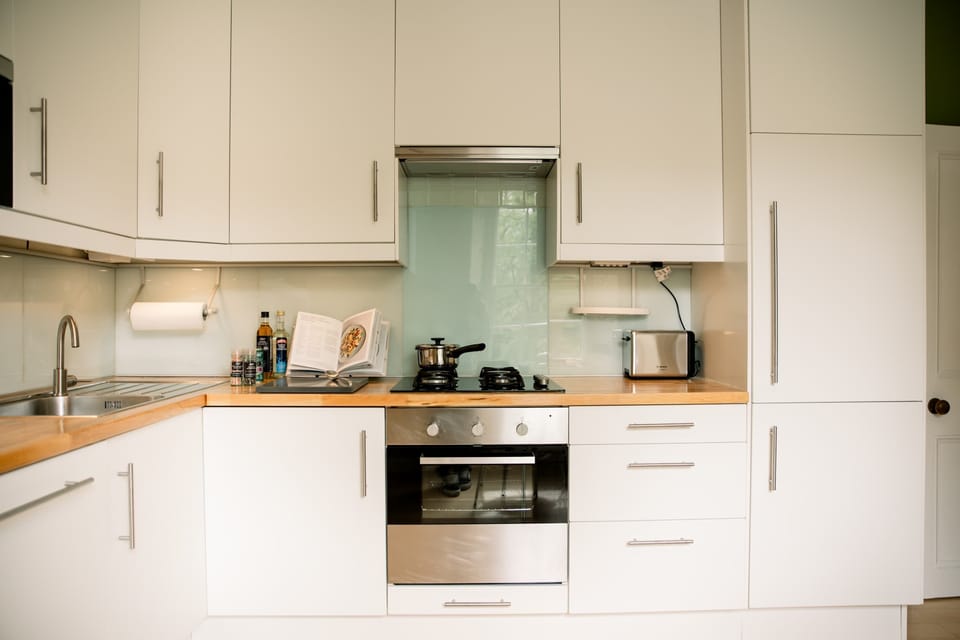 Sleek white kitchen w/ modern finishes & plenty of space for home-cooked meals