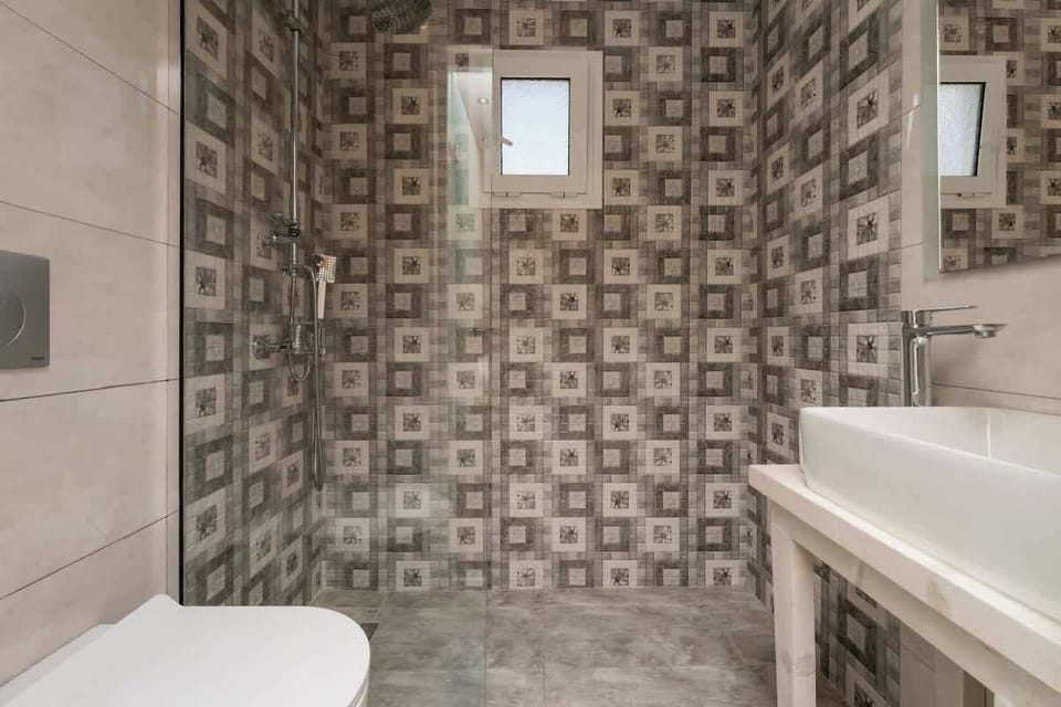 Modern bathroom with walk-in shower and fresh towels