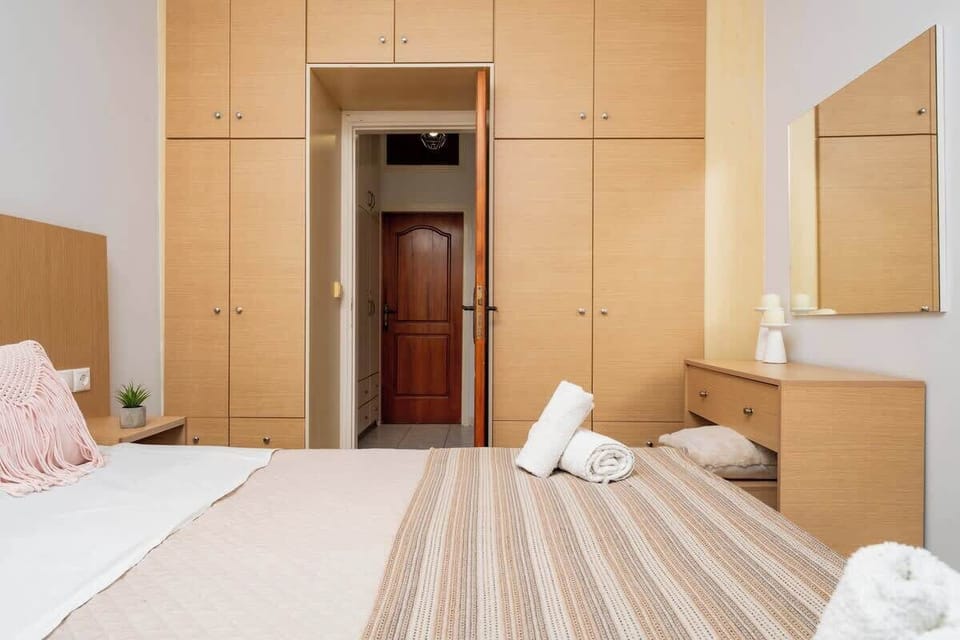 Elegant bedroom with comfortable bedding and storage space