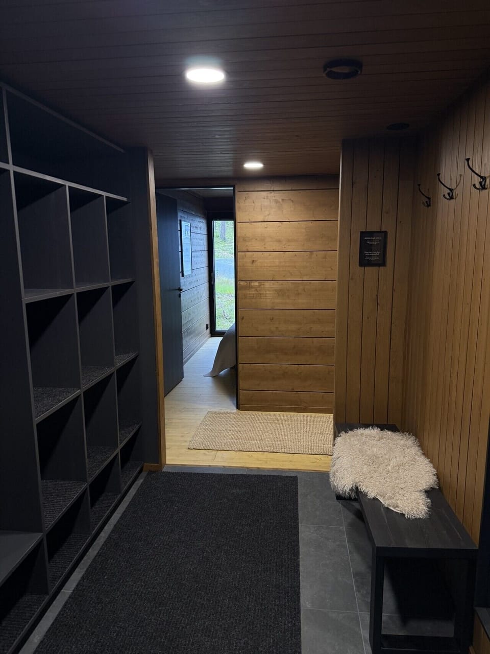 Spacious entryway storage keeps outer layers and bulky winter gear neatly organized near the door. It ensures the main living spaces remain clear and open.