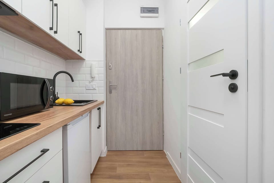 A clean and minimalist entrance hallway. It provides a neat and welcoming access to the studio.