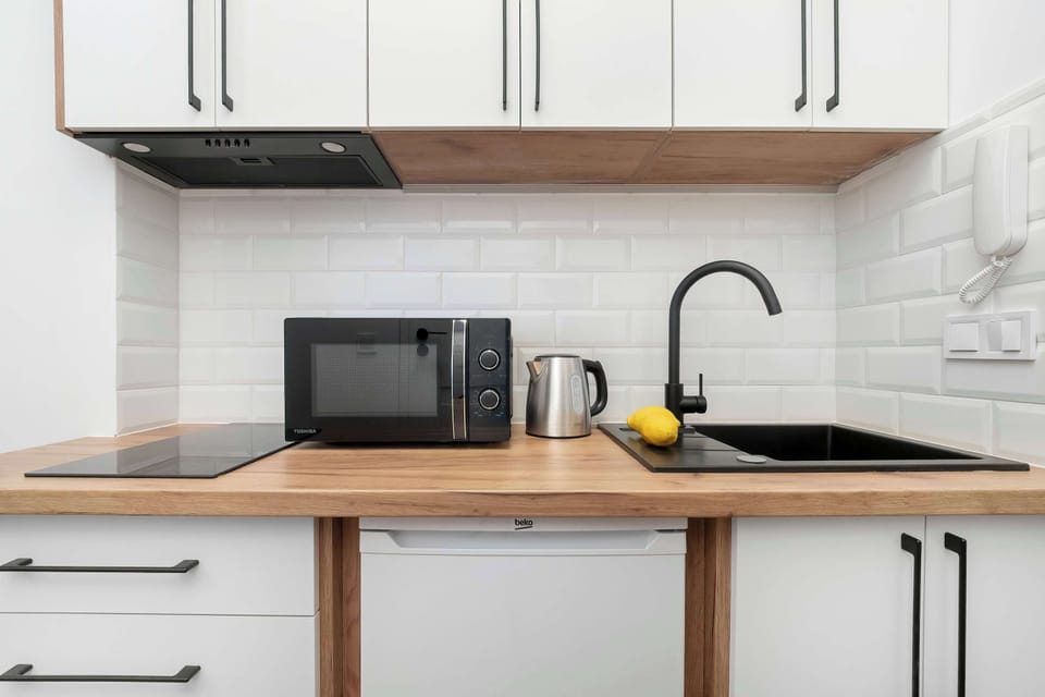 A functional kitchenette area with a microwave and essential appliances. It gives you everything you need for convenient cooking.