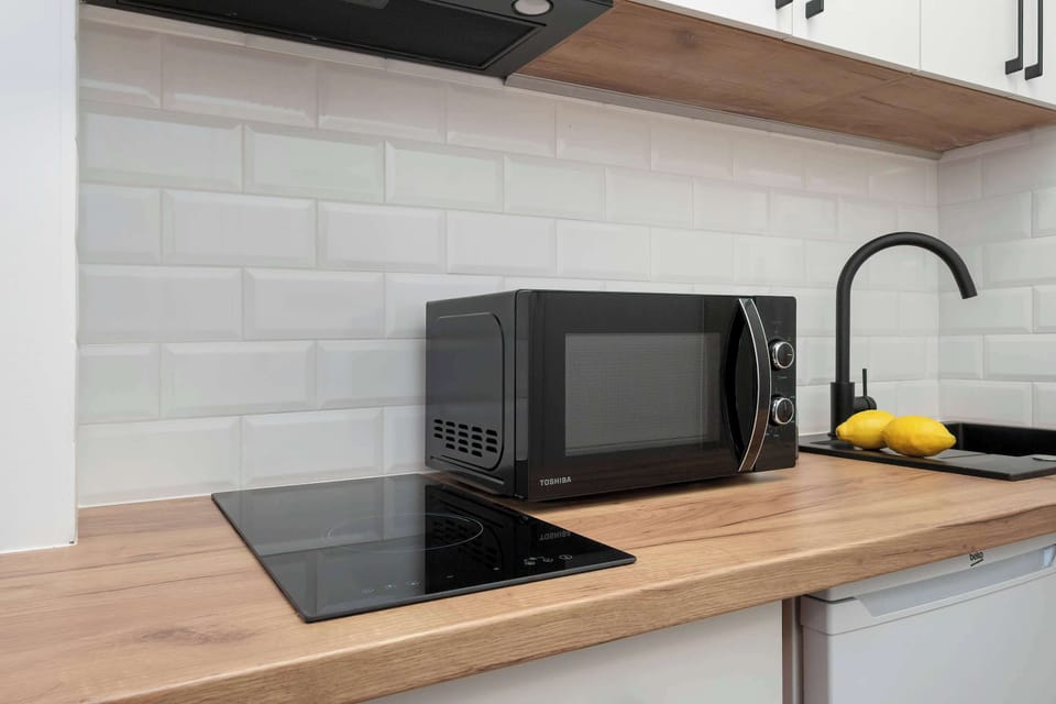 A modern kitchenette with an induction hob, sink, and countertop. It allows you to easily prepare simple meals.