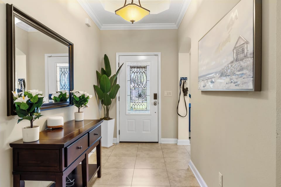 7:58 PMClaude responded: Grand foyer with soaring tray ceiling, decorative glass front door, and elegant dark wood entryway console.Grand foyer with soaring tray ceiling, decorative glass front door, and elegant dark wood entryway console.